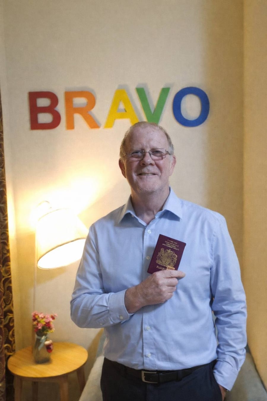Happy retirement-visa client with his passport at Bravo Visa Service Phuket